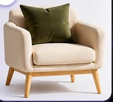 Reference photo of a cream armchair with an olive cushion