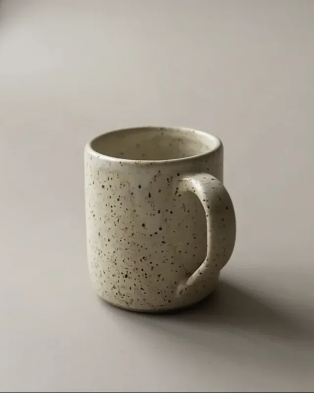 Generated three-quarter view of a speckled ceramic mug from a Product turnaround set.