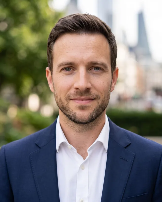 Example headshot outdoors, greenery blurred behind