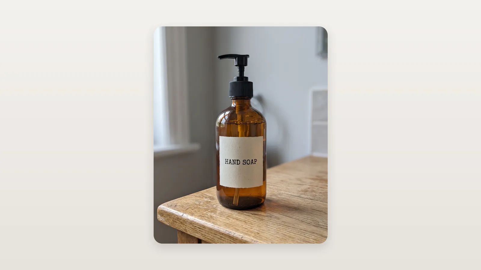 An amber soap bottle photographed on a wooden table, the label facing the camera